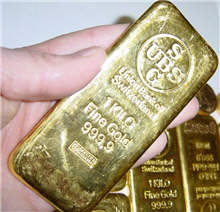 A gold bar stamped with 1 kilogram.